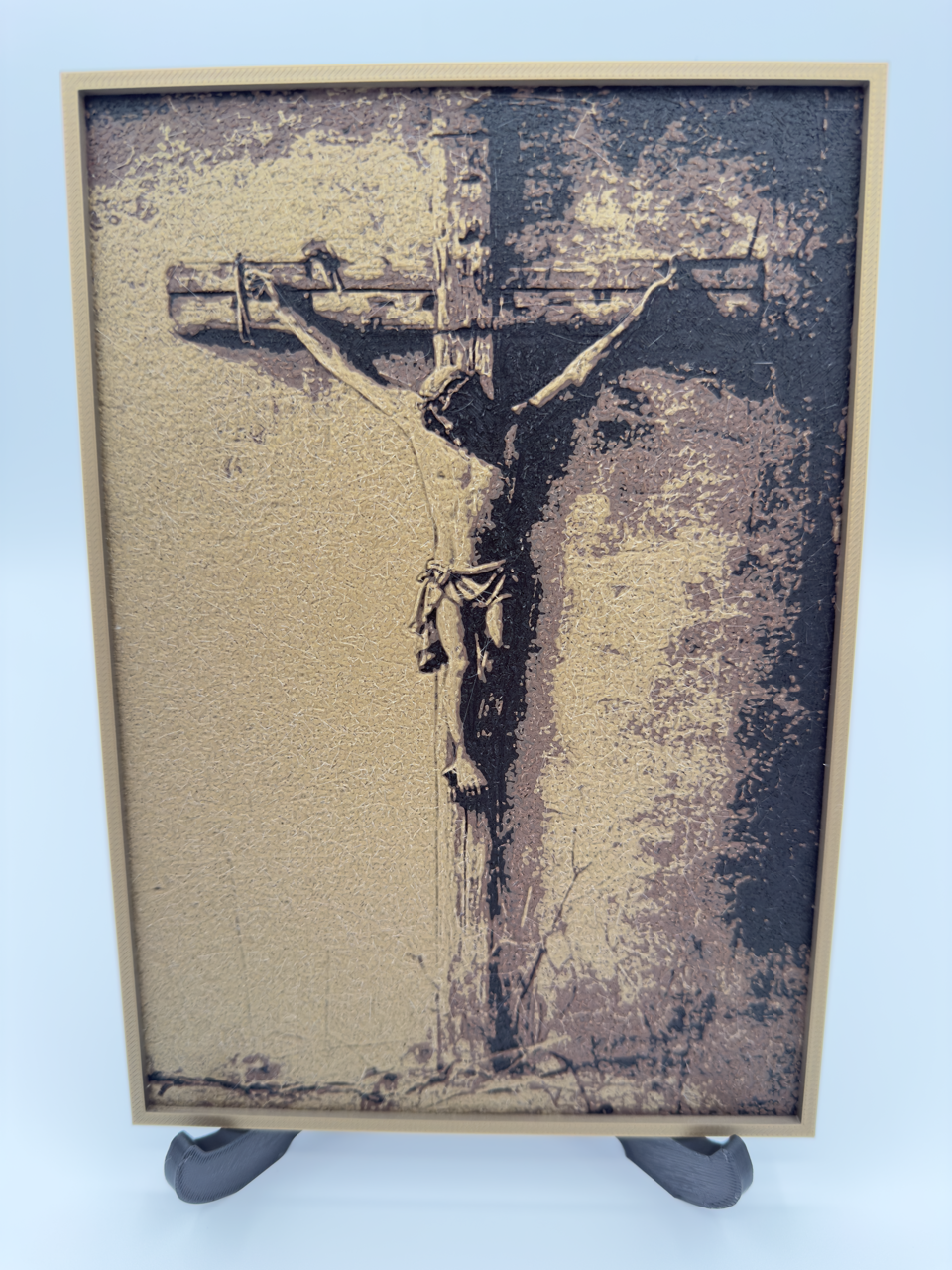 Framed artwork of a crucifixion on a textured background
